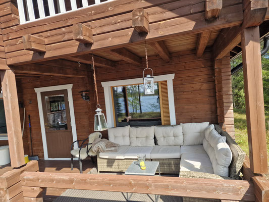 Terrasse couverte du chalet avec canapé et table
