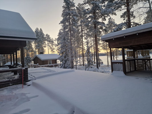 Snow-covered courtyard between wooden buildings