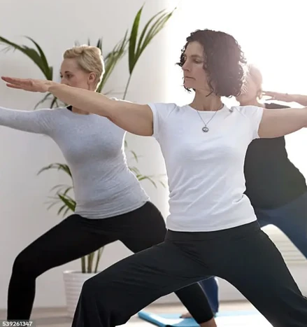 Dos mujeres practicando juntas una postura de yoga